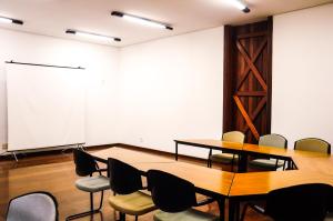 a conference room with tables and chairs and a whiteboard at Canto da Floresta Ecoresort in Amparo +95 photos