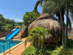 a resort with a swimming pool and a slide at Goodhope Villa in Sam Roi Yot