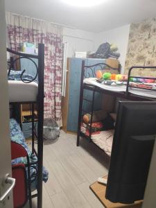 a room with bunk beds and a tv in it at Blue Horizon Apartments 