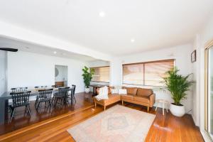 a living room with a couch and a table at The Happy Pelican Harrington Hotel in Harrington
