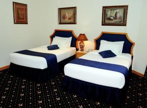 Ένα ή περισσότερα κρεβάτια σε δωμάτιο στο Cayam Hotel