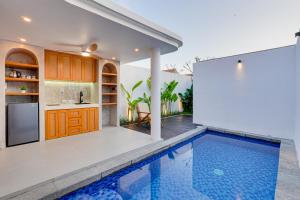 a kitchen and a swimming pool in a house at Charming 1BR Villa Gypsophila Laluxe A16 Sanur in Sanur