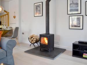 a living room with a wood stove in it at The Old Chapel in Grosmont