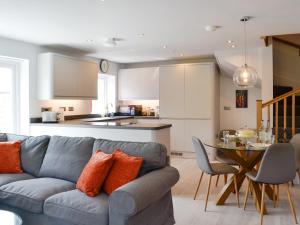a living room and kitchen with a couch and a table at The Old Chapel in Grosmont