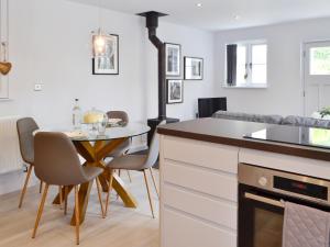 a kitchen with a table and a dining room at The Old Chapel in Grosmont