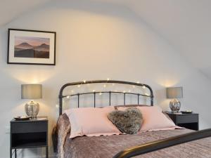 a bedroom with a bed with two night stands at The Old Chapel in Grosmont +7 photos