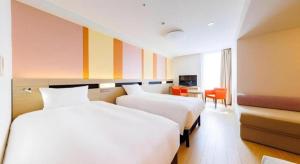 a hotel room with two beds and a desk at Hotel Dream Gate Maihama Annex in Chiba +158 photos