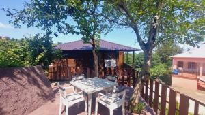 a table and chairs in front of a house at Stillwood Tsikhisdziri in Kobuleti