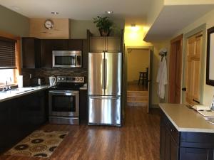a kitchen with a large stainless steel refrigerator at Freedom Lodge & Spa in Madeira Park