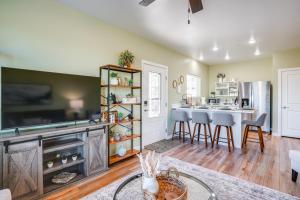 a living room with a fireplace and a kitchen with a table at Panoramic View! Prescott Casita Near Mtns and Hiking in Chino Valley
