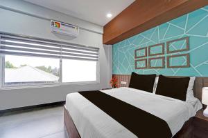 Voodi või voodid majutusasutuse Super Hotel O KSRTC Bus Terminal Venjarammoodu Formerly Downtown toas