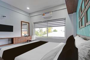 Voodi või voodid majutusasutuse Super Hotel O KSRTC Bus Terminal Venjarammoodu Formerly Downtown toas