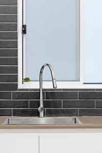 a kitchen sink with a faucet next to a window at Cozy Double Room in Kensington - Walk to UNSW Easy CBD Access -External and Shared Kitchen or Bathroom Access in Sydney