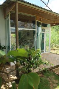 a screened in porch of a house at Rosee de Kala - Golden Buurin in Di Linh +8 photos