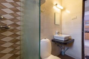 a bathroom with a toilet and a sink at Luxury 2BHK Apartment Near Candolim Beach in Candolim +18 photos
