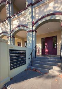 a building with a garage door and some stairs at Stunning One Bedroom Apartment in Fitzroy in Melbourne