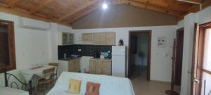 a kitchen with a white refrigerator and a table at Panorama Palaiοpolis in Palaiopoli