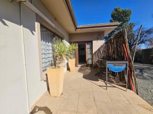 a porch of a house with plants and a fence at Stay at 126 in Bloemfontein