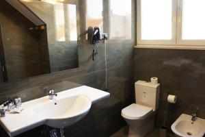 
a bathroom with a sink, toilet and bathtub at Bairro Alto Suites in Lisbon
