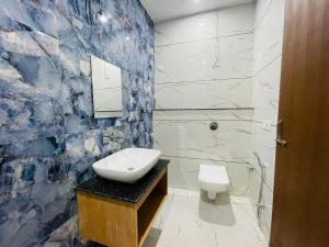 a bathroom with a sink and a toilet at Hotel Pilgrim Near Golden Temple in Amritsar