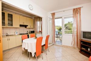 a kitchen and dining room with a table and chairs at Villa Stana in Vinišće