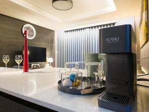 a kitchen with a blender on a counter with wine glasses at Vourne Osiria in Busan