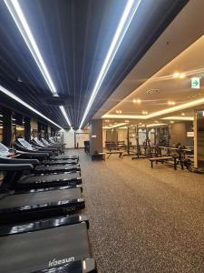 a gym with a row of treadmills and benches at Vourne Osiria in Busan