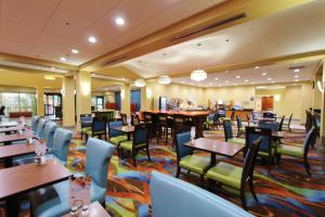uma sala de jantar com mesas e cadeiras e mesa de cabeceira em Holiday Inn Express Flagstaff by IHG em Flagstaff