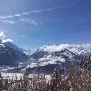 a view of a snowy mountain range with snow covered mountains at Gadenstätter Apartments in der City in Zell am See