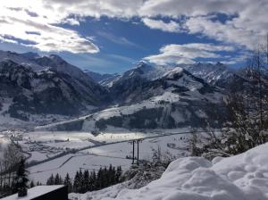 a view of a snow covered mountain range with a bridge at Gadenstätter Apartments in der City in Zell am See