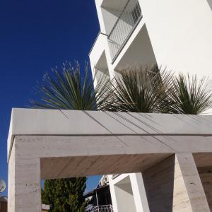 a white building with plants on top of it at Bila Vila Apartments in Zaboric