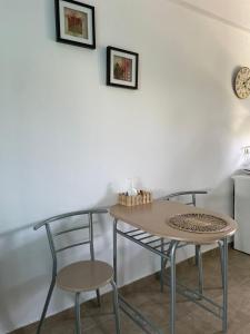 a table and two chairs in a room at Lemi Apartments in Rizá +21 photos