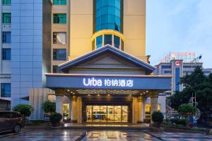 a building with a sign that reads uigi hotel at Quanzhou West Street Wanda Plaza Urbain Hotel in Quanzhou