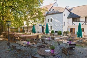 a patio with tables and chairs in front of a building at Gasthaus Ochsenwirt in Landshut