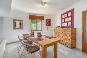 ein Esszimmer mit einem Holztisch und Stühlen in der Unterkunft Villa Andaluza in Almuñécar