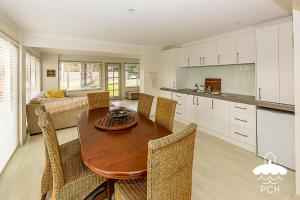 a kitchen and dining room with a table and chairs at Family Tidez in Sandy Point