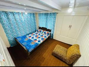 a room with a bed and a chair in it at Gypsys Hostel in Srinagar