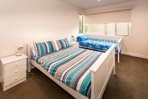 Un dormitorio blanco con una cama y una ventana. en 69 Beach Parade Sandy Point 3959, en Sandy Point