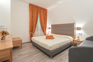 a hotel room with a bed and a window at Hotel Il Buongustaio in Massa