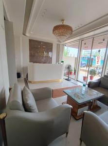 a living room with couches and a coffee table at Hotel K A Square in Bhopal