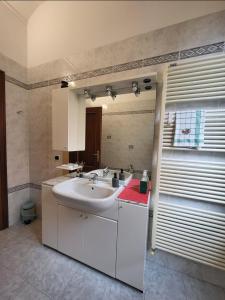 a bathroom with a sink and a mirror at Quiet Tortellini in Modena +25 photos