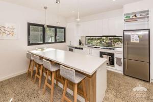 a kitchen with a white counter and a refrigerator at 1 Anderson Avenue Sandy Point in Sandy Point +6 photos
