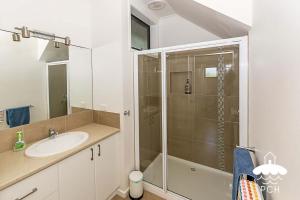 a bathroom with a shower and a sink at 37 Oceanview Parade Sandy Point in Sandy Point +7 photos