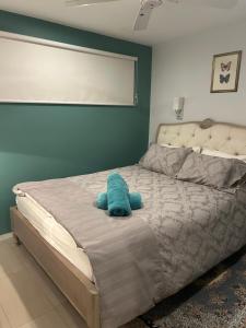 a bed with a blue stuffed animal on it at Whitfords Retreat - 2 Bedroom unit in Perth