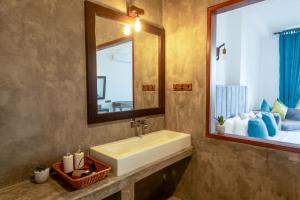 a bathroom with a sink and a mirror at Nethra Beach in Hikkaduwa +40 photos