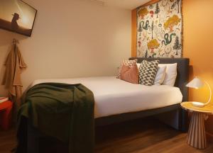 a small room with a bed with white sheets and pillows at Little Drifter Glebe in Sydney