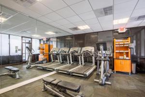 a gym with several treadmills and machines in it at Econo Lodge Naval Station Norfolk in Norfolk