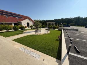 a parking lot with a park with a field of grass at The Nook in Pădureni