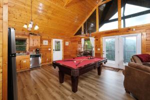 a living room with a pool table in it at Edge of Paradise in Pigeon Forge