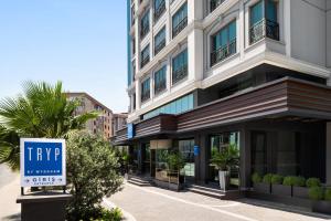 a tall building with a sign in front of it at TRYP by Wyndham Istanbul Maltepe in Istanbul
